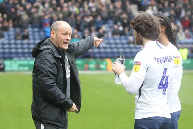 PNE boss Alex Neil gives instructions to Ben Pearson and Daniel Johnson during a break in play