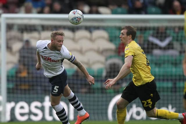 Preston skipper Tom Clarke beats Jon Dadi Bodvarsson to the ball