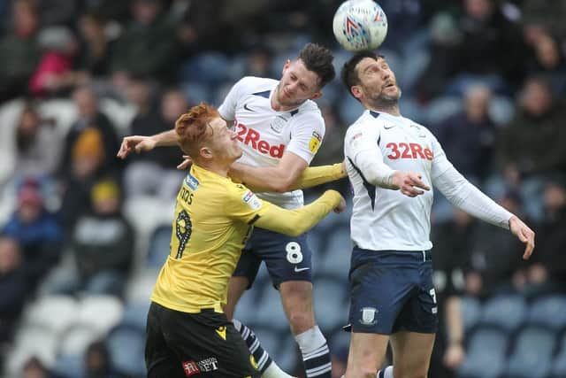 David Nugent and Alan Browne challenge in the air against Millwall
