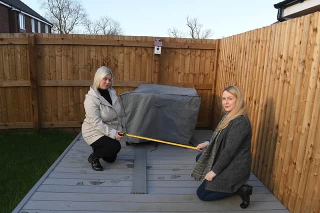 Residents Gemma Barnes (left) and Carley Crook assess how much of their gardens they are likely to lose.