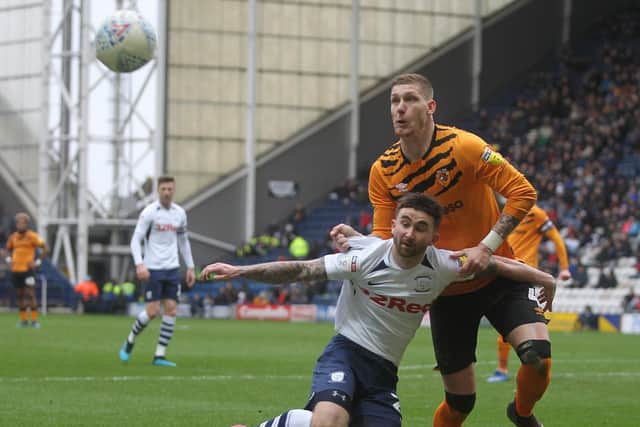 Preston striker Sean Maguire tussles with Hull defender Jordy De Wijs