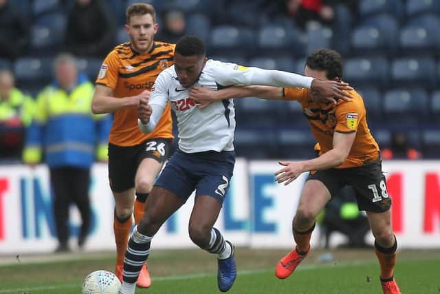 Preston right-back Darnell Fisher holds of Hull City midfielder George Honeyman