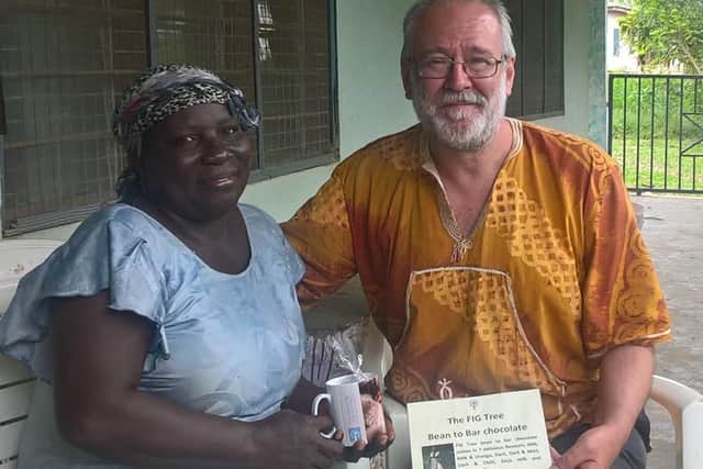 Bruce Crowther  presents Patricia Adwubi, cocoa farmer from New Koforidua,  with FIG Tree chocolate made using her farm's cocoa beans in August 2019.