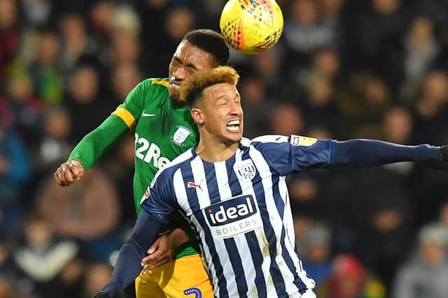 Preston right-back Darnell Fisher challenges West Brom's Callum Robinson in the air at The Hawthorns