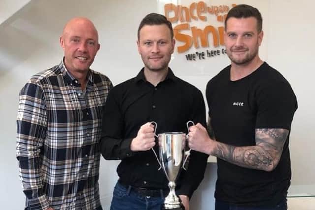 Pictured with The Reece Holt Cup trophy at UOAS head quarters are, from left, Kieran Murphy (Ambassador for The Reece Holt Cup), Daniel Jillings (co-founder of Once Upon A Smile) and Dave Holt (Reece's uncle and founder of The Reece Holt Cup).