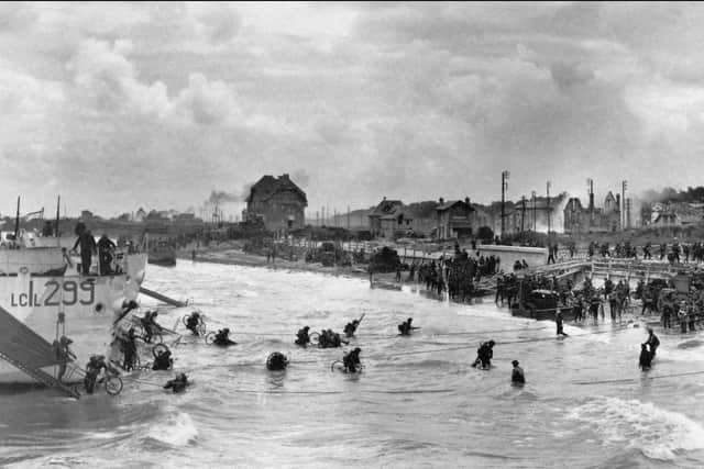 Allied troops go ashore on D-Day.