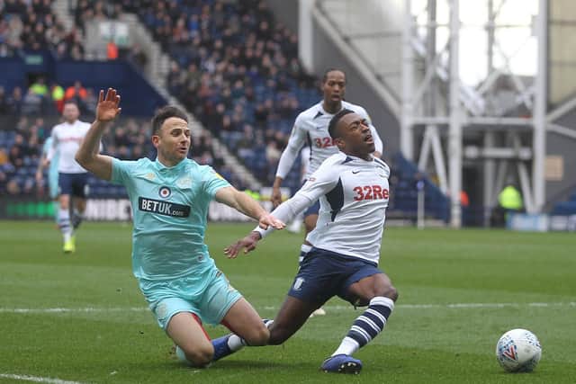 Preston right-back Darnell Fisher is fouled by QPR's Marc Pugh for PNE's penalty