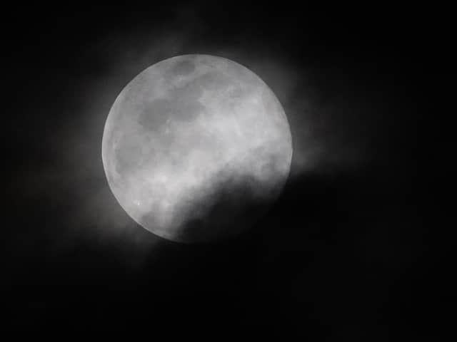 A super worm moon, occurring on the same day as the equinox, is seen through passing clouds in March 2019 (Picture:SAUL LOEB/AFP via Getty Images)