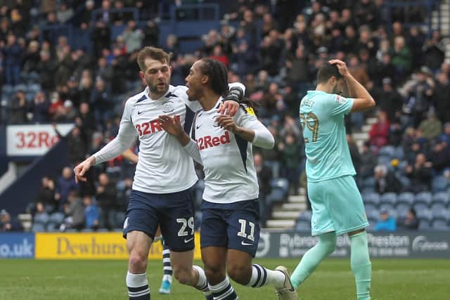 Daniel Johnson celebrates with Tom Barkhuizen after giving Preston the lead against QPR at Deepdale