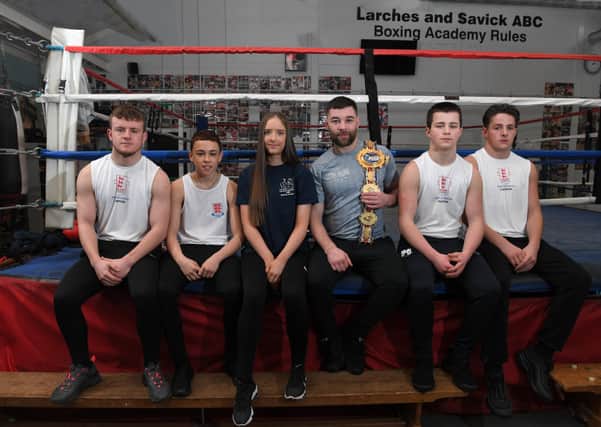 Young boxing champions at Larches and Savick ABC Boxing Academy, from the left, Owen Strickland, Layton Hobson, Maddock McPartland, Patrick Gavin and Jimmy Gavin with Scott Fitzgerald (third from right) Photo: Neil Cross