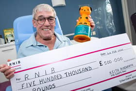 'Sooty Man' Keith Ainsworth with his cheque and Sooty collection tin. Photo: Kelvin Stuttard