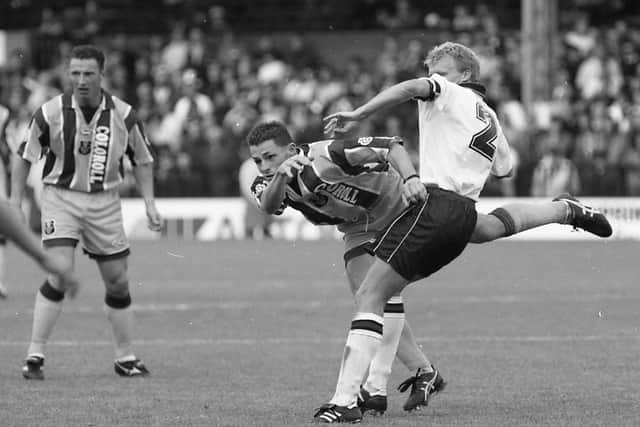 PNE winger Gareth Ainsworth challenges with a Fulham defender for the ball, watched by Ian Bryson