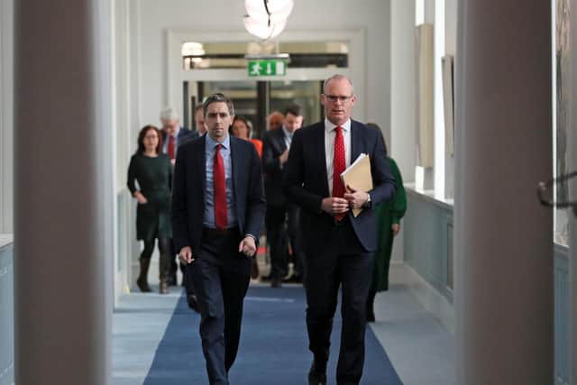 Minister for Health Simon Harris (left) and Tnaiste Simon Coveney (right) walk to a news conference at Government Buildings in Dublin