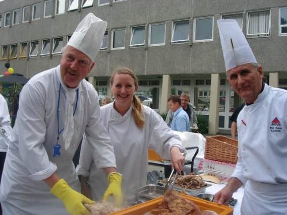 On the left, chef Peter Stead at a barbecue when he was a catering lecturer