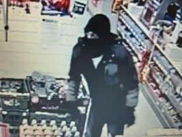 One of the suspects at the scene of the robbery at Spar in Broadfield Drive, Leyland on Sunday night (March 15)
