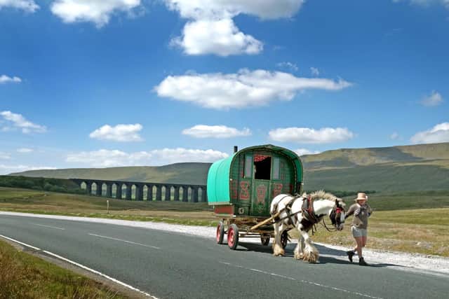 A romany caravan passes Ribblehead Viaduct on the way to the Appleby Horse Fair last year. This years event has been cancelled due to the coronavirus pandemic