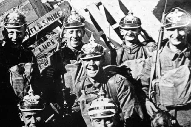 Loyal North Lancashire soldiers wearing captured German pickelhaube  in Cambrai, October 1918