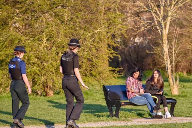 Avon and Somerset Police officers chat to people in a park in Bristol, where they are patrolling and enforcing the coronavirus lockdown rules. PA Photo. Picture date: Thursday March 26, 2020. Photo credit should read: Ben Birchall/PA Wire