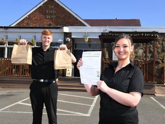 Ram's Head staff Charlie Jeffries and Lexi Whelan showing off the pub's new takeaway service