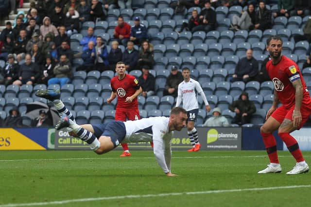 Louis Moult scores for Preston North End with a diving header against Wigan in August 2019 at Deepdale