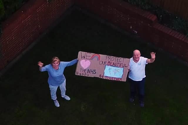 A still from the film showing two residents offering a touching tribute to the NHS.