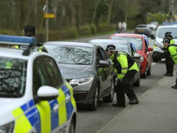 Police officers check motorists in Garstang Road, Preston.