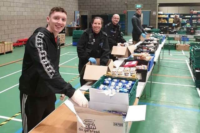 Police staff help out at the emergency hub at Salt Ayre
