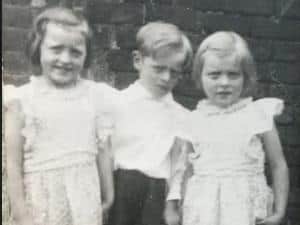 Pictured aged 3. L to R: Teresa, John , Pauline.