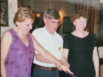 Cutting their 50th birthday cake in 2000