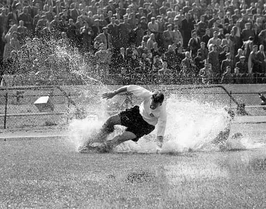 Sir Tom Finney in action for Preston North End against Chelsea at Stamford Bridge in August 1956 - the famous 'Splash' picture