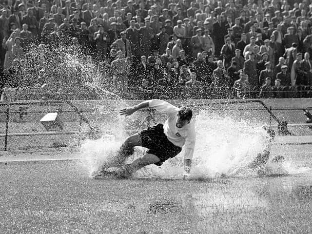 Sir Tom Finney in action for Preston North End against Chelsea at Stamford Bridge in August 1956 - the famous 'Splash' picture