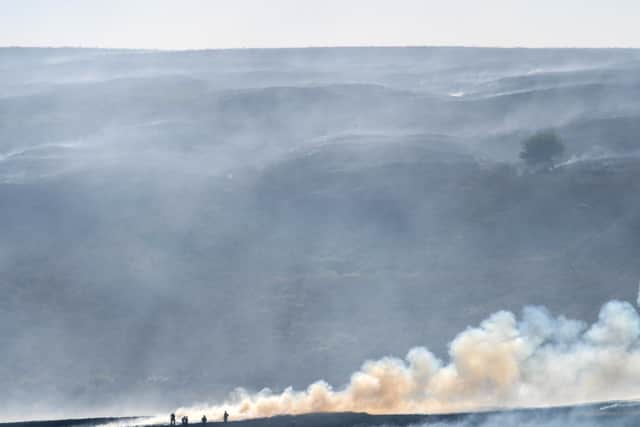 A distant view of Winter Hill near Bolton, shows the massive task firefighters are facing to control hundreds of smouldering embers on July 2, 2018 (Photo by Christopher Furlong/Getty Images)