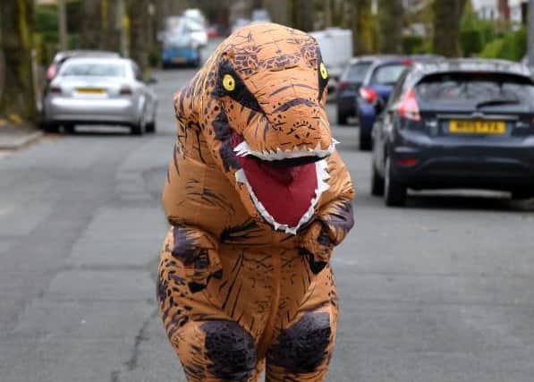 Olivia on the street in her dino suit
Photo: Neil Cross