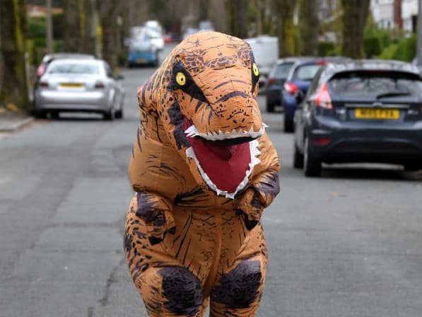 Olivia on the street in her dino suit
Photo: Neil Cross