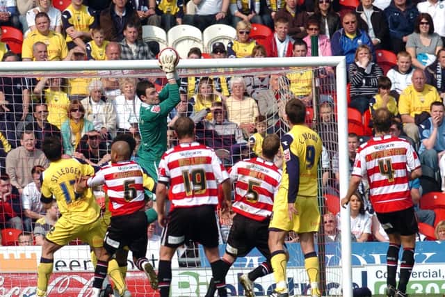 Preston goalkeeper Andrew Lonergan catches a cross in front of the PNE fans at Doncaster in April 2009