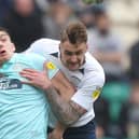 Preston defender Patrick Bauer battles with QPR striker Jordan Hugill