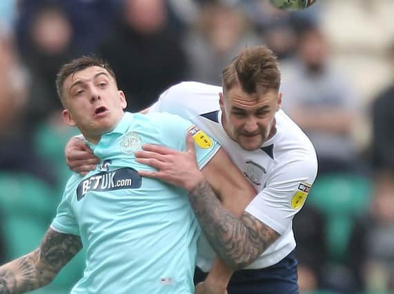 Preston defender Patrick Bauer battles with QPR striker Jordan Hugill