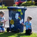 Charlie, 7, and Bradley, 5, paint their wheelie bin to show their appreciation to the binmen.