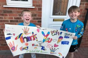 Theo and Freddy with their flag for the NHS and key workers.