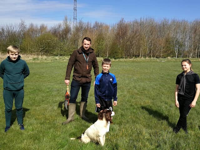 Taking a break from their desks,,, Aspire pupils with Roe the Springer Spaniel helps bring outdoor learning to life.