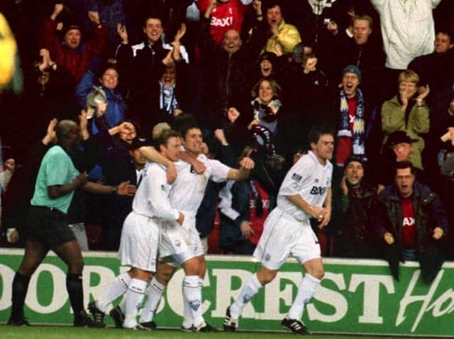 PNE defender Michael Jackson celebrates in front of the North End fans at Wigan with Paul McKenna and Graham Alexander