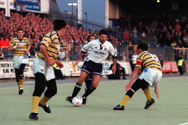 Preston striker Tony Ellis takes on the Torquay defence on the final game on plastic at Deepdale