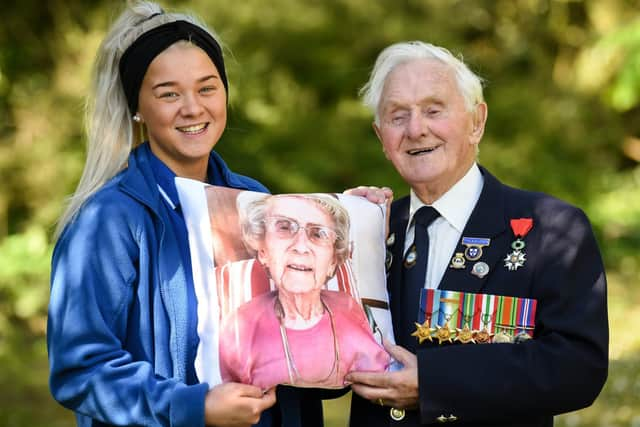 Thistleton Lodge Care Home resident Ken Benbow and carer Kia Tobin with the cushion of his late wife, Ada.