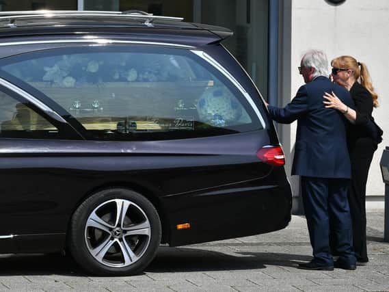 Syd Little and his wife, Sheree, pay their respects to his comedy legend partner Eddie Large, before the hearse drove through the streets of Portishead towards South Bristol Crematorium