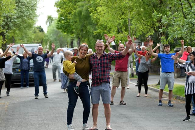 Andy and Jen Green, pictured with son Eddie, two, have been entertaining neighbours by blasting out Sweet Caroline