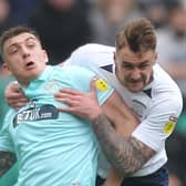 Jordan Hugill tussles with Patrick Bauer during Preston’s clash with Queens Park Rangers at Deepdale in March