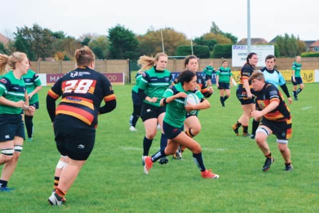 The women's rugby team playing last season.
