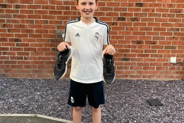 Ollie Ascroft gets ready for his daily charity  run to school