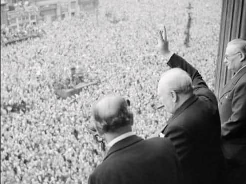 Prime Minister Winston Churchill gives his famous victory salute on VE-Day in 1945.