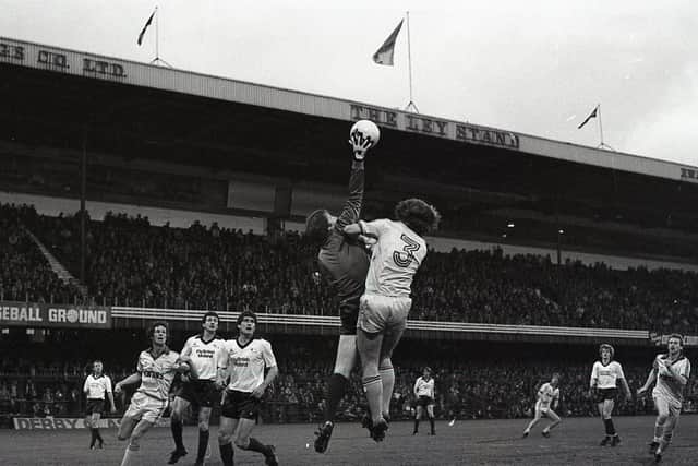 Preston's John Anderson challenges the Derby goalkeeper Roger Jones in the air